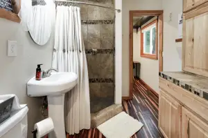 Highland & Co. Acres Shipping Container Home - Spacious Bathroom with Tiled Shower
